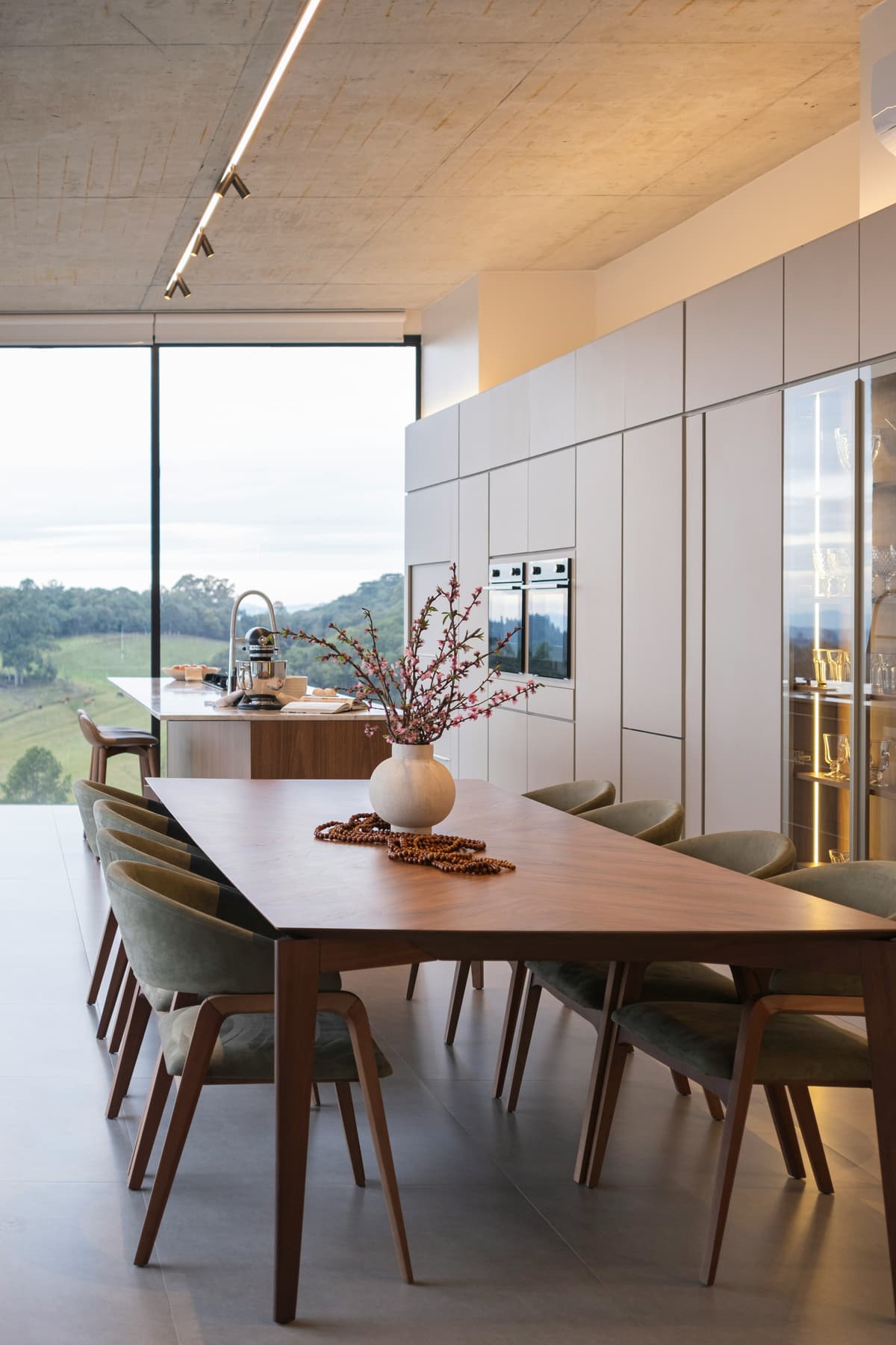 Pale painted kitchen and dining space looking out over open countryside